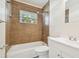 Updated bathroom with tub, toilet, and vanity at 831 Searcy Ave, Sarasota, FL 34237