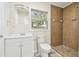 Updated bathroom with shower, toilet and brown tile at 831 Searcy Ave, Sarasota, FL 34237