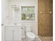 Updated bathroom, featuring a shower and wood-look floors at 831 Searcy Ave, Sarasota, FL 34237
