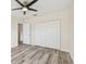 Bedroom with wood-look floors, ceiling fan and double door closet at 831 Searcy Ave, Sarasota, FL 34237