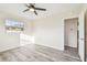 Spacious bedroom with wood-look floors, ceiling fan, and access to another room at 831 Searcy Ave, Sarasota, FL 34237