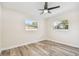 Bright bedroom with wood-look floors, ceiling fan, and ample closet space at 831 Searcy Ave, Sarasota, FL 34237