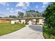 Tan house with white fence and a landscaped yard at 831 Searcy Ave, Sarasota, FL 34237