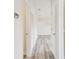 Light-filled hallway with wood-look floors and access to other rooms at 831 Searcy Ave, Sarasota, FL 34237