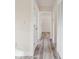 Bright hallway with wood-look floors and doors at 831 Searcy Ave, Sarasota, FL 34237