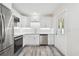 Modern kitchen with white cabinets and stainless steel appliances at 831 Searcy Ave, Sarasota, FL 34237