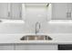 Modern kitchen sink and countertops with updated faucet at 831 Searcy Ave, Sarasota, FL 34237