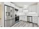 Modern kitchen with stainless steel appliances and white cabinets at 831 Searcy Ave, Sarasota, FL 34237