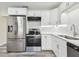 Modern kitchen with white cabinets and stainless steel appliances at 831 Searcy Ave, Sarasota, FL 34237