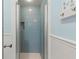 Updated bathroom with blue tile shower and white trim at 546 18Th Ne Ave, St Petersburg, FL 33704