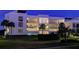 Condo building exterior at night, well lit at 50 Coe Rd # 311, Belleair, FL 33756