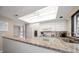 Well-equipped kitchen with white cabinets, granite countertops and stainless steel appliances at 50 Coe Rd # 311, Belleair, FL 33756