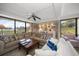 Relaxing living room features a comfortable sectional sofa, a large window with golf course views, and hardwood floors at 50 Coe Rd # 311, Belleair, FL 33756