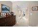 Long hallway with mirrored closet doors and neutral carpeting at 50 Coe Rd # 311, Belleair, FL 33756