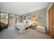 Guest bedroom with a queen-size bed and sliding door access to balcony at 50 Coe Rd # 311, Belleair, FL 33756