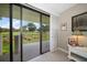 Bedroom with sliding glass doors leading to a balcony overlooking a lush golf course at 50 Coe Rd # 311, Belleair, FL 33756