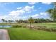 Lush green golf course with palm trees and waterfront views at 50 Coe Rd # 311, Belleair, FL 33756