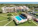 Aerial view of condo building and pool at 50 Coe Rd # 311, Belleair, FL 33756