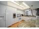 Modern kitchen with white cabinets, granite countertops, and stainless steel appliances at 50 Coe Rd # 311, Belleair, FL 33756