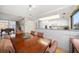 Bright dining area with wood table and chairs, and open kitchen views at 50 Coe Rd # 311, Belleair, FL 33756