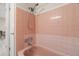 Pink tiled bathroom with shower and tub at 6483 25Th N St, St Petersburg, FL 33702