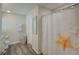 Clean bathroom with shower, toilet, and a stylish starfish shower curtain at 13043 Pennybrook Dr, Riverview, FL 33579