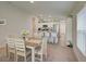 Bright dining room features a wood table with white chairs, overlooking the kitchen at 13043 Pennybrook Dr, Riverview, FL 33579