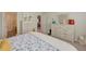 Main bedroom with dresser, spacious bed, and view into bathroom at 13043 Pennybrook Dr, Riverview, FL 33579