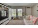 Cozy living room features comfortable seating and large windows overlooking backyard at 13043 Pennybrook Dr, Riverview, FL 33579