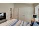 Main bedroom with double doors to closet and view of adjacent room at 13043 Pennybrook Dr, Riverview, FL 33579