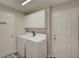 Laundry room with washer, dryer, and ample cabinet space at 13043 Pennybrook Dr, Riverview, FL 33579
