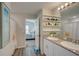 Bathroom with granite countertop, double sinks, and view of bedroom at 13043 Pennybrook Dr, Riverview, FL 33579