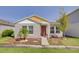 Cute one-story home with a red door and yellow trim at 13043 Pennybrook Dr, Riverview, FL 33579