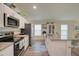 Modern kitchen with white cabinets, granite countertops, and stainless steel appliances at 13043 Pennybrook Dr, Riverview, FL 33579
