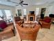 Community room furnished with wicker chairs and a fireplace at 702 Lyndhurst St # 824, Dunedin, FL 34698