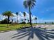 Entrance to the Fenway community with palm trees and a waterfront view at 702 Lyndhurst St # 824, Dunedin, FL 34698