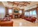 Elegant living room with a stone fireplace and leather sofas at 1227 Osowaw Blvd, Spring Hill, FL 34607