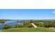 Aerial view showcasing waterfront property with dock and footbridge at 1227 Osowaw Blvd, Spring Hill, FL 34607