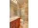 Elegant bathroom with granite countertops, walk-in shower and wood cabinets at 1227 Osowaw Blvd, Spring Hill, FL 34607