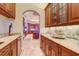 Butler's pantry with granite countertops and custom cabinetry at 1227 Osowaw Blvd, Spring Hill, FL 34607