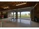 Large garage with multiple garage doors opening to scenic waterfront views at 1227 Osowaw Blvd, Spring Hill, FL 34607