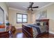 Bright bedroom with hardwood floors, plantation shutters, and a comfortable bed at 1227 Osowaw Blvd, Spring Hill, FL 34607