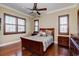 Comfortable bedroom with hardwood floors, plantation shutters and a wooden bed frame at 1227 Osowaw Blvd, Spring Hill, FL 34607