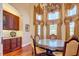 Formal dining room with a round glass-top table and ornate chairs at 1227 Osowaw Blvd, Spring Hill, FL 34607