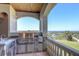 Luxury outdoor kitchen with stainless steel appliances and water views at 1227 Osowaw Blvd, Spring Hill, FL 34607