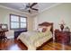 Charming bedroom with wood flooring, plantation shutters and a wooden bed frame at 1227 Osowaw Blvd, Spring Hill, FL 34607