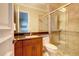 Modern bathroom with granite countertop, walk-in shower, and wood cabinets at 1227 Osowaw Blvd, Spring Hill, FL 34607