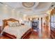 Luxurious main bedroom with fireplace, hardwood floors, and ornate bed at 1227 Osowaw Blvd, Spring Hill, FL 34607