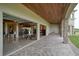 Covered patio with pavers adjacent to a large garage, offering outdoor space at 1227 Osowaw Blvd, Spring Hill, FL 34607