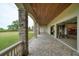 Covered patio adjacent to a large garage, overlooking a grassy yard at 1227 Osowaw Blvd, Spring Hill, FL 34607